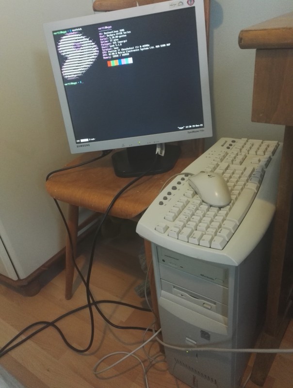 Syys in tower configuration with a monitor sitting on a chair next to it